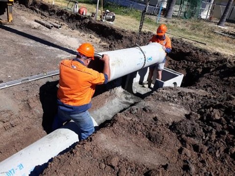 Workers installing water pipe