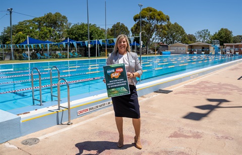 Councillor Megan James standing beside pool